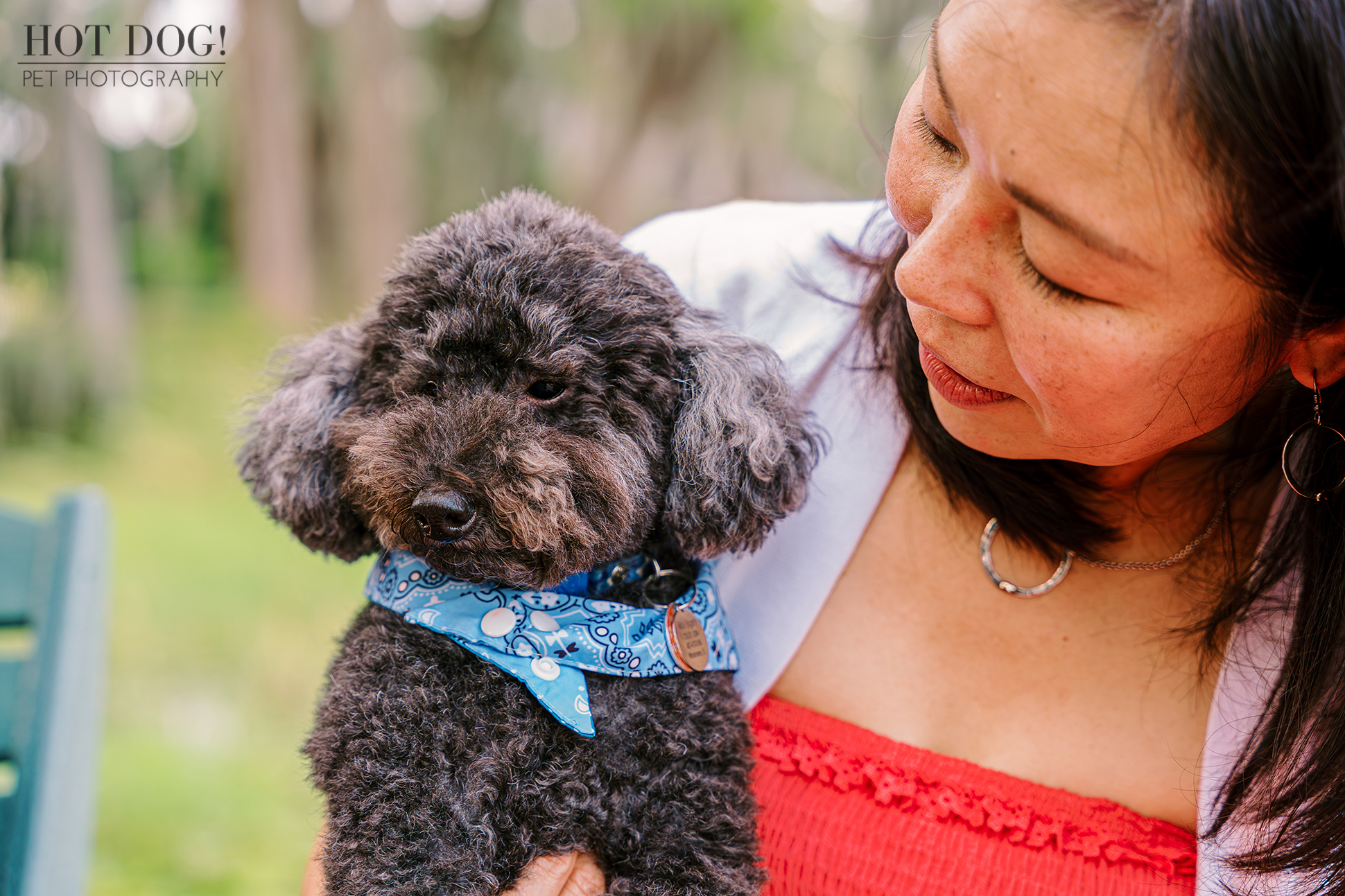 A woman holds a dog gently in her arms, symbolizing love and connection between them.